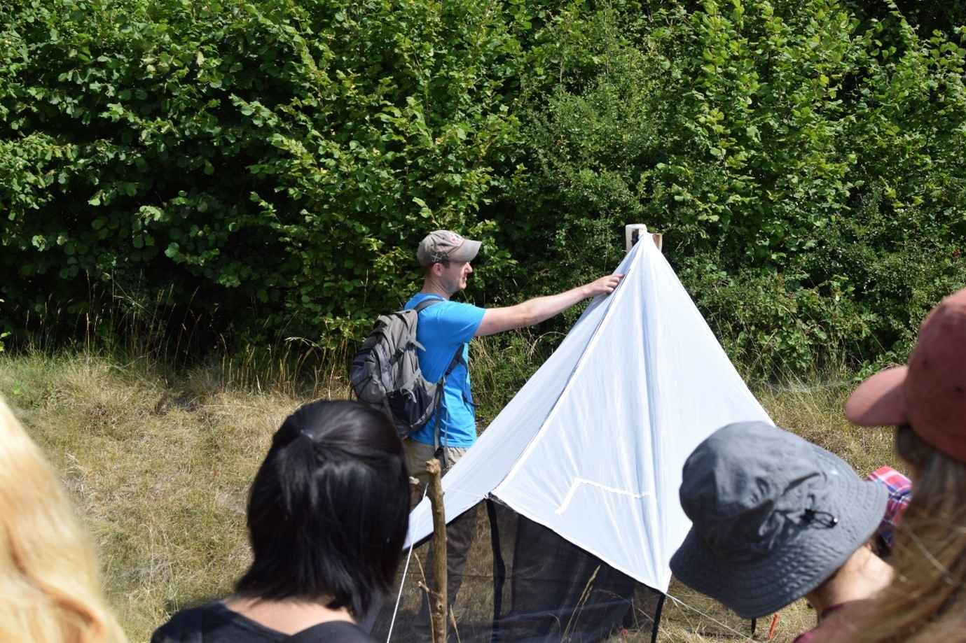 Liam Crawley showing students how to set up a Malaise trap.
