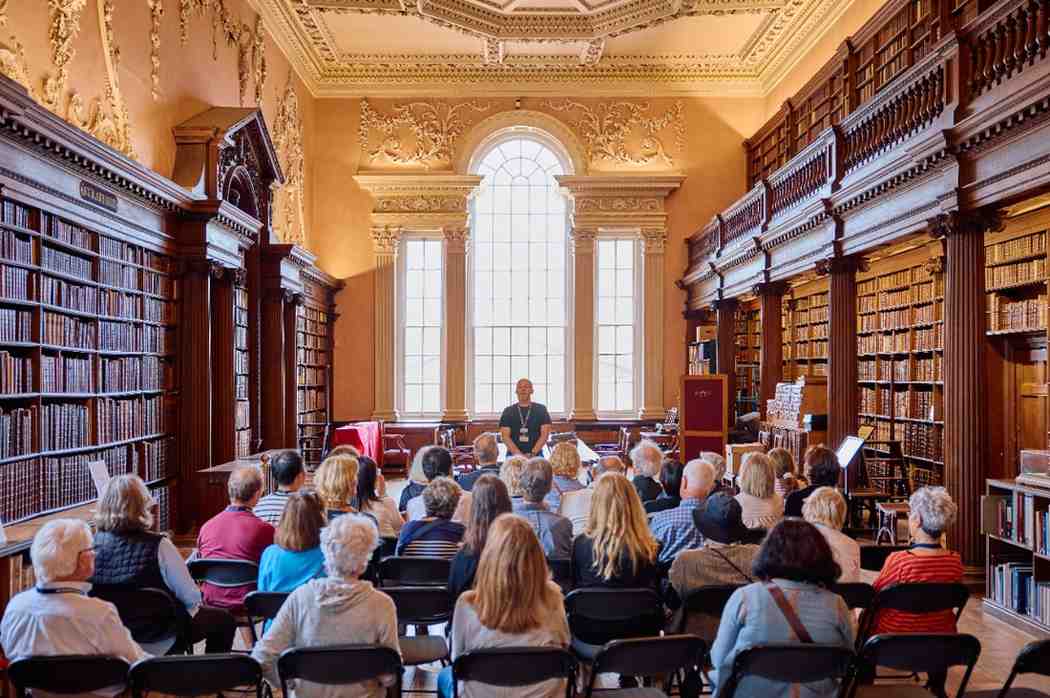 People listening to a talk in a library at Christ Church