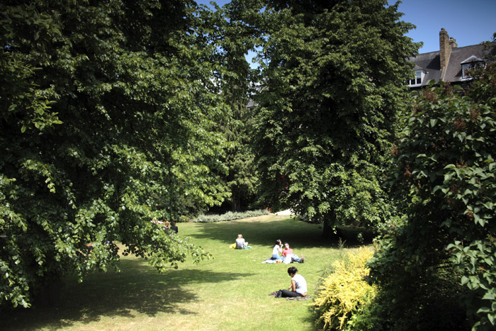 People sitting in Wellington Square garden on the grass