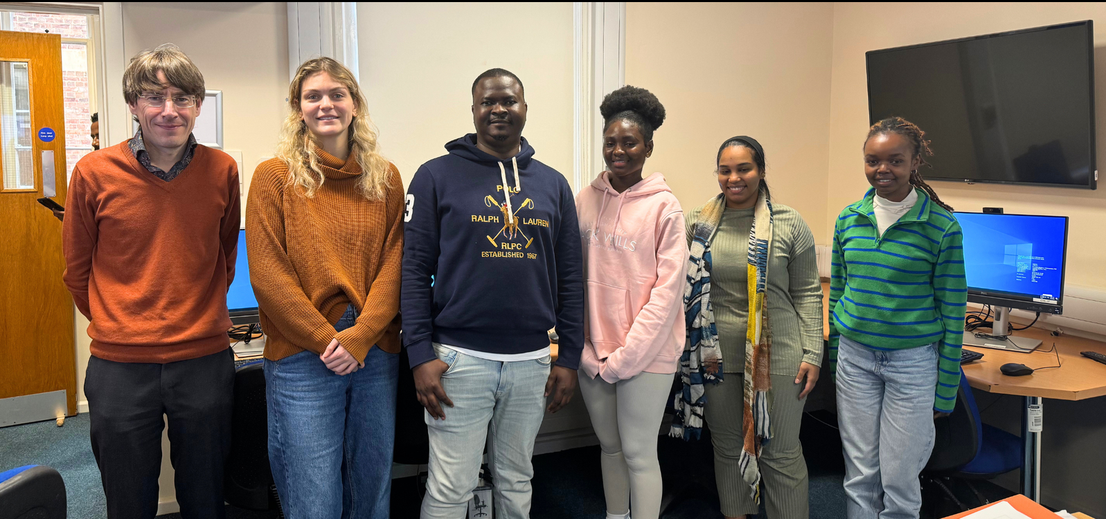 Dr Ben Grant, tutor and students together in a coding workshop