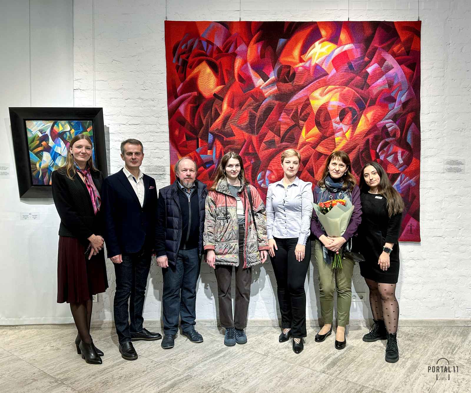 A group of seven colleagues at the tapestry exhibition in Kyiv, Ukraine.